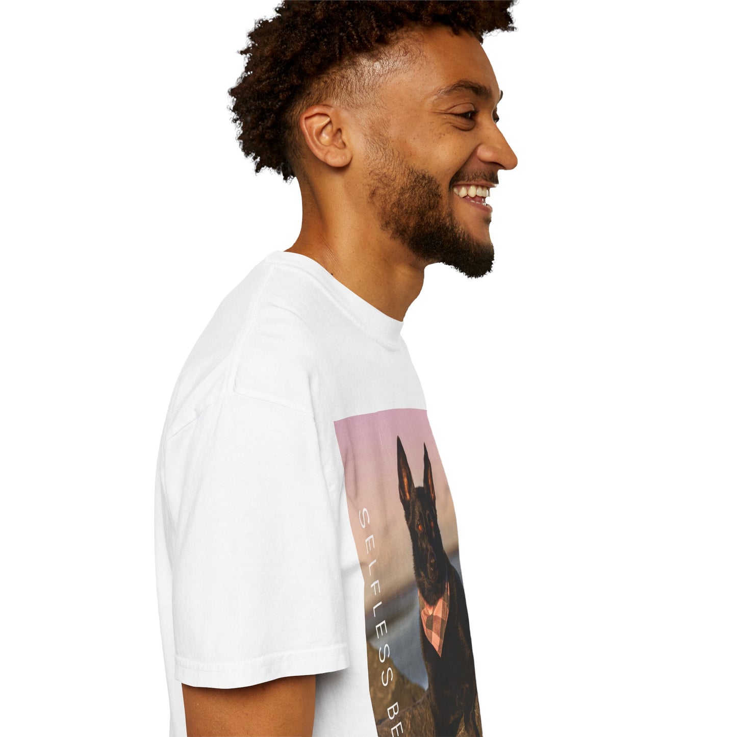 Unisex Dog Lover T-shirt With Solid Black German Shepherd Wearing a Romal Sitting on the Seaside Rocks and Caption Selfless Beings