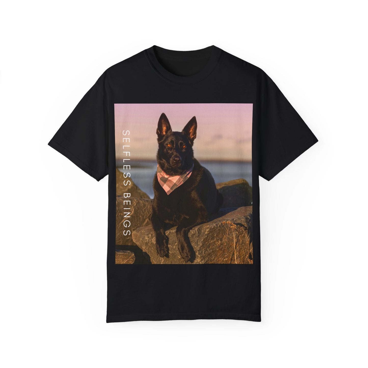Unisex Dog Lover T-shirt With Solid Black German Shepherd Wearing a Romal Sitting on the Seaside Rocks and Caption Selfless Beings