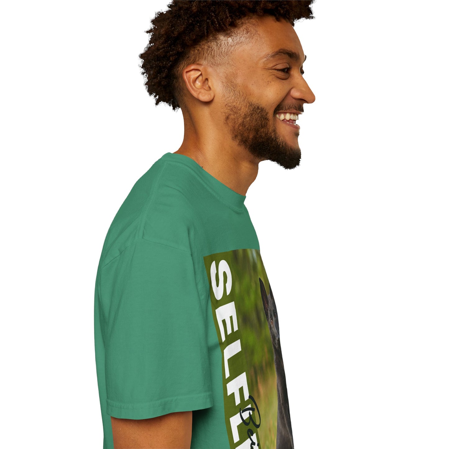 Unisex Dog Lover T-Shirt With Solid Black German Shepherd Puppy Sloppily Sitting on the Green Pasture and Caption Selfless Beings
