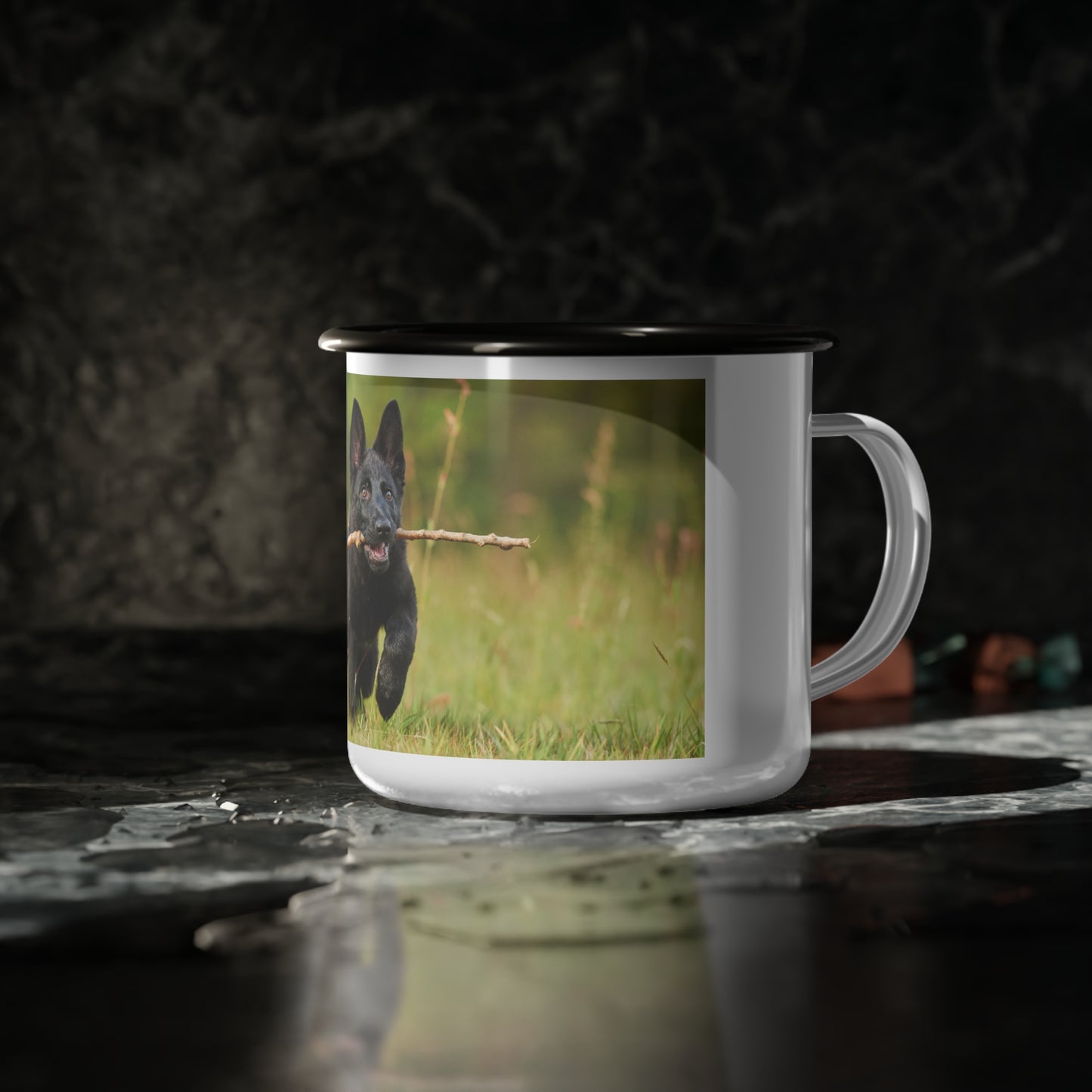 Nature-Inspired Enamel Camp Cup – Black German Shepherd Puppy Holding a Wood Piece In Mouth Running on the Grass