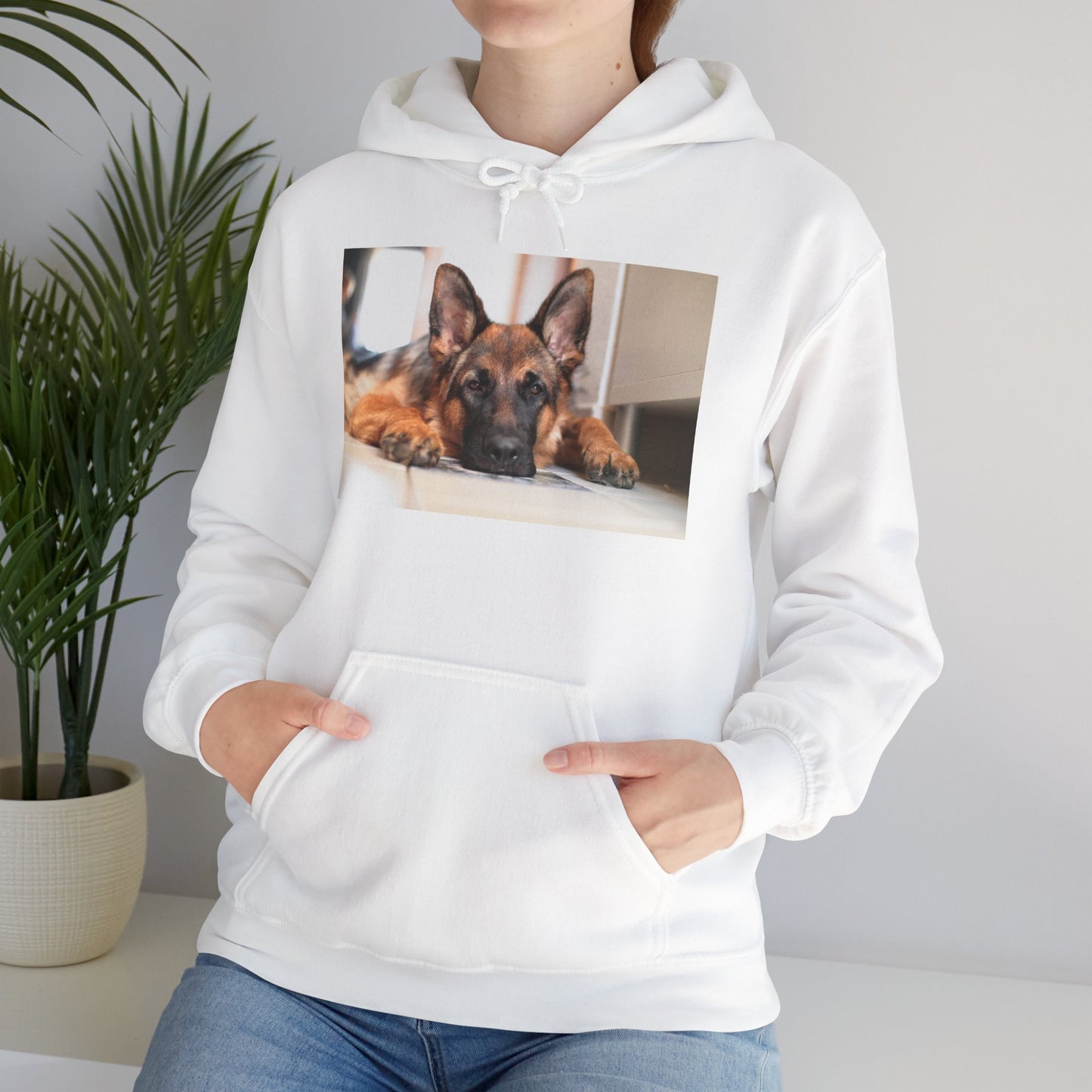 A Unisex Hoodie With a German Shepherd Lying His Head on the Floor