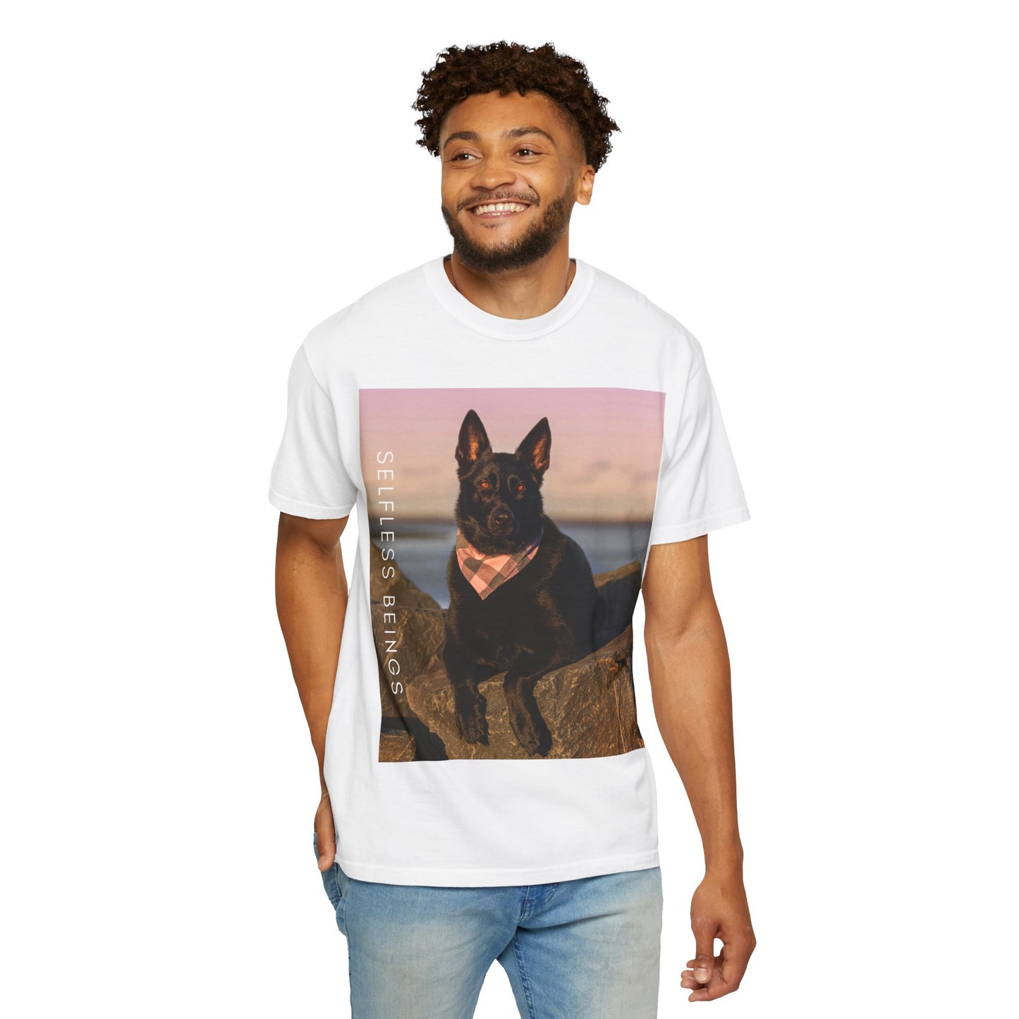 Unisex Dog Lover T-shirt With Solid Black German Shepherd Wearing a Romal Sitting on the Seaside Rocks and Caption Selfless Beings