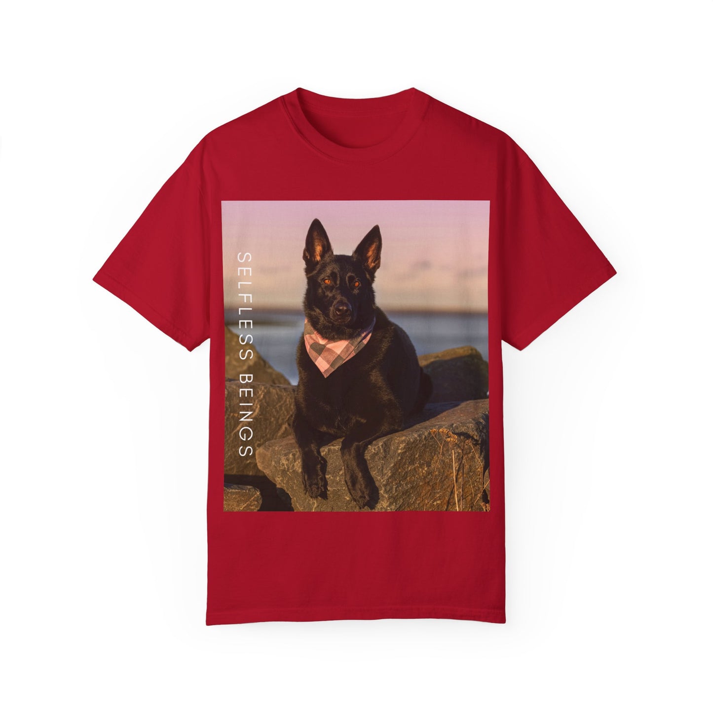 Unisex Dog Lover T-shirt With Solid Black German Shepherd Wearing a Romal Sitting on the Seaside Rocks and Caption Selfless Beings