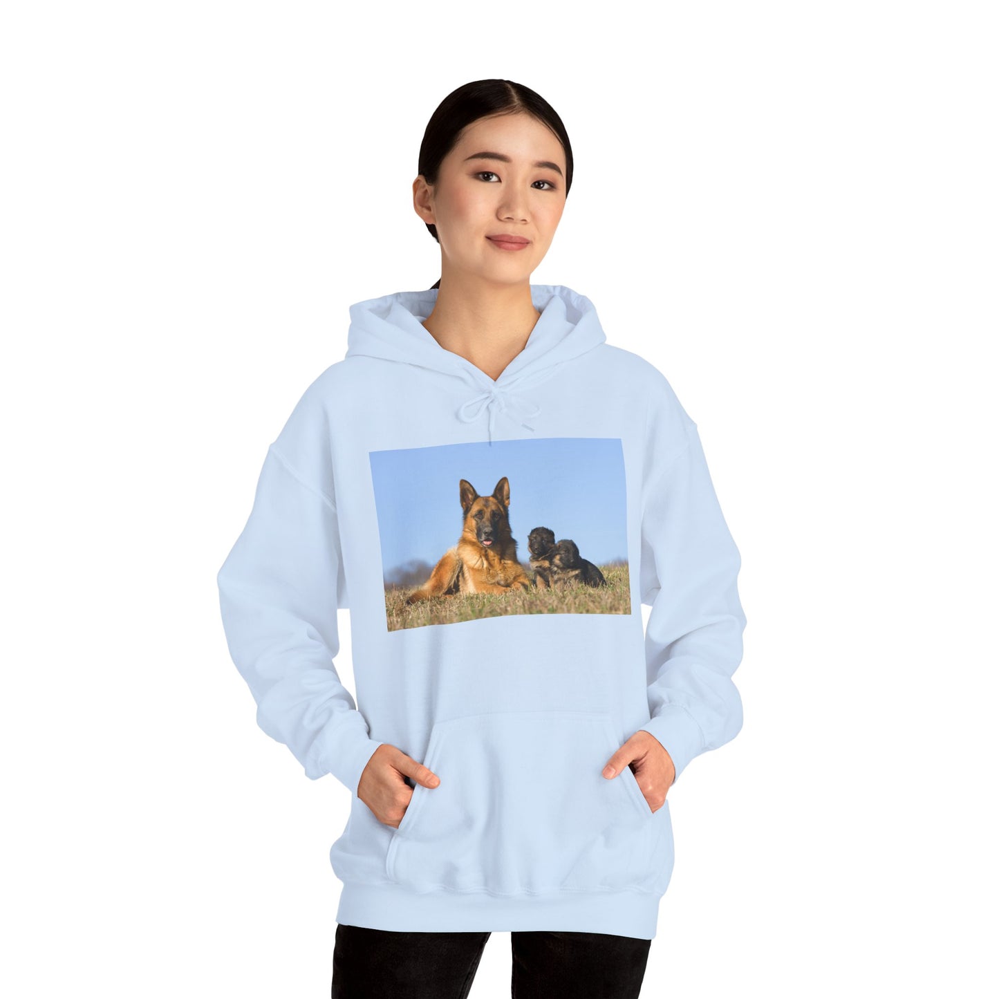 A Unisex Dog Lover Hoodie With a German Shepherd Lying on the Grass With Two Puppies