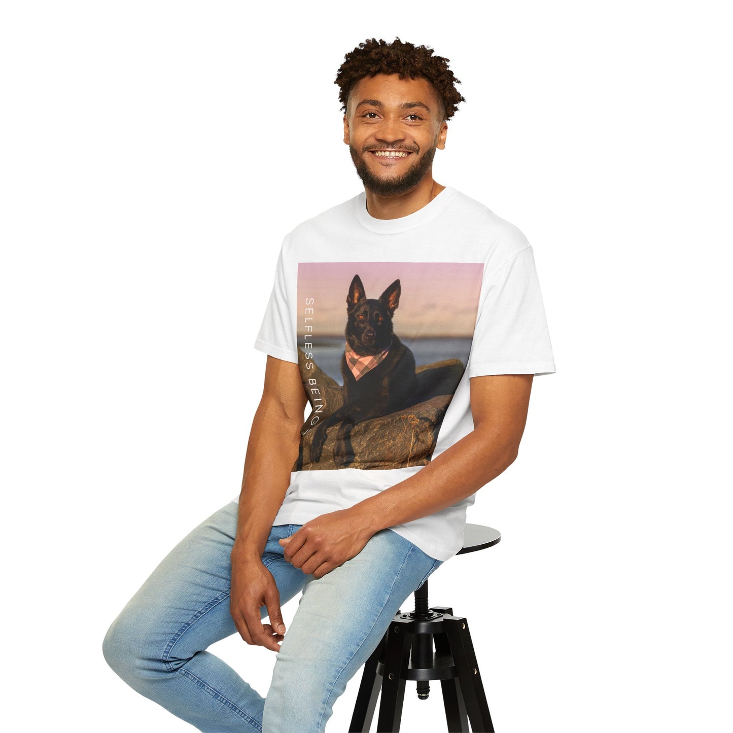 Unisex Dog Lover T-shirt With Solid Black German Shepherd Wearing a Romal Sitting on the Seaside Rocks and Caption Selfless Beings